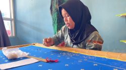 Leni, Pengrajin Tudung Manto sedang asyik menyulam merangkai motif di sehelai kain agar menjadi tudung manto yang cantik, elegan, mewah tanpa meninggalkan khasanah budaya Melayu.